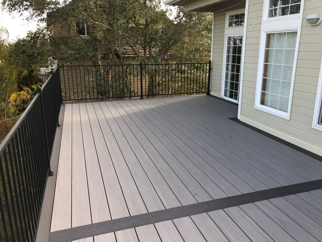 Gray deck with black railing.
