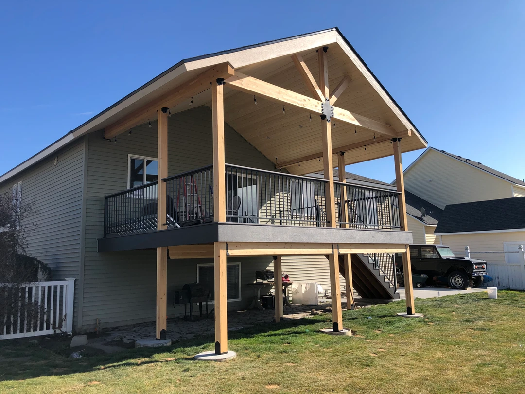Deck with railing and a cover.