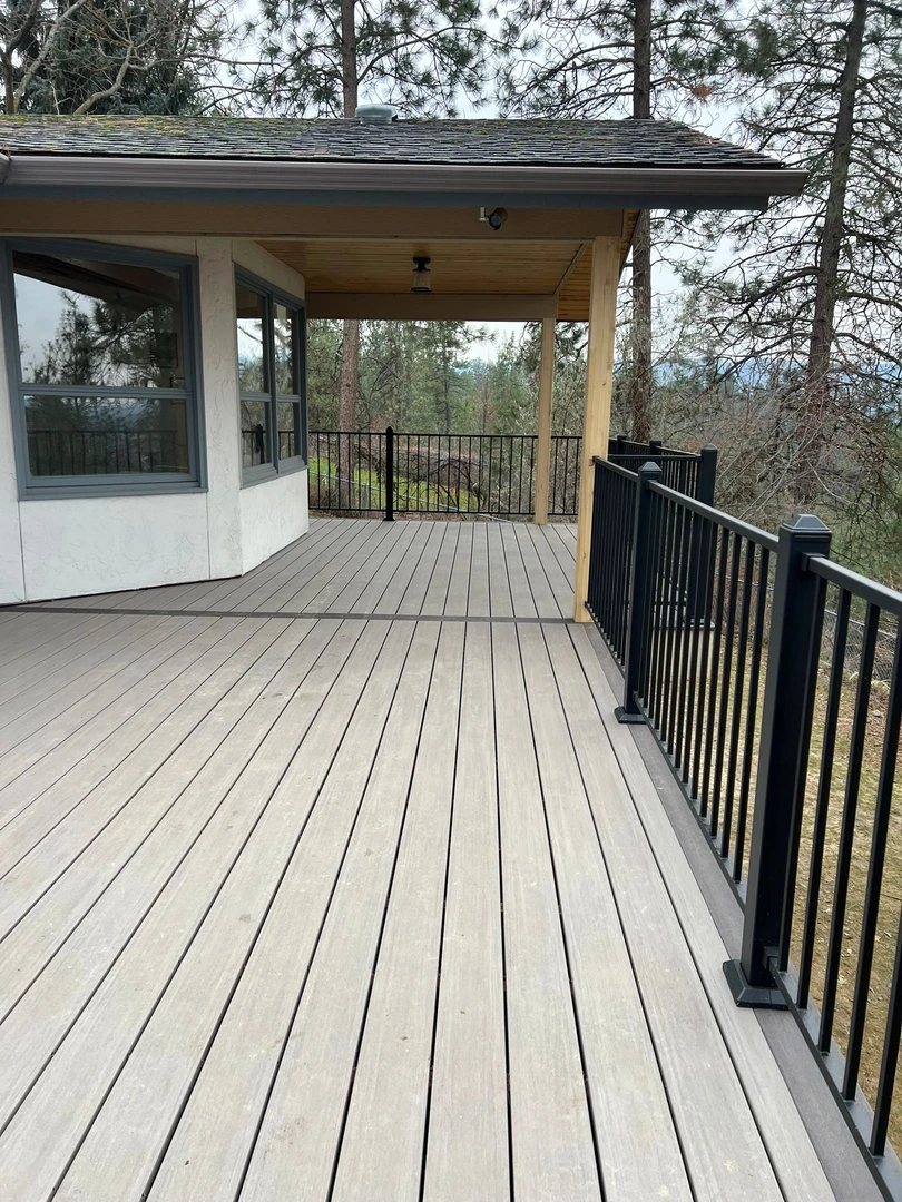 Deck with cover and black railing.