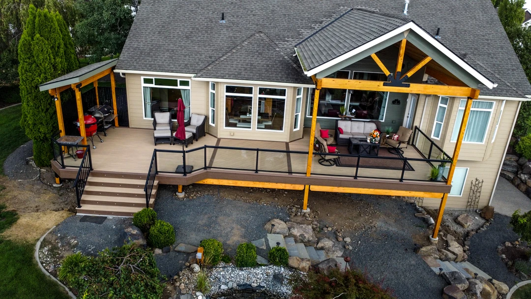 Deck with railing, stairs, lighting, and a big kingpost cover. Privacy walls are over on the side.