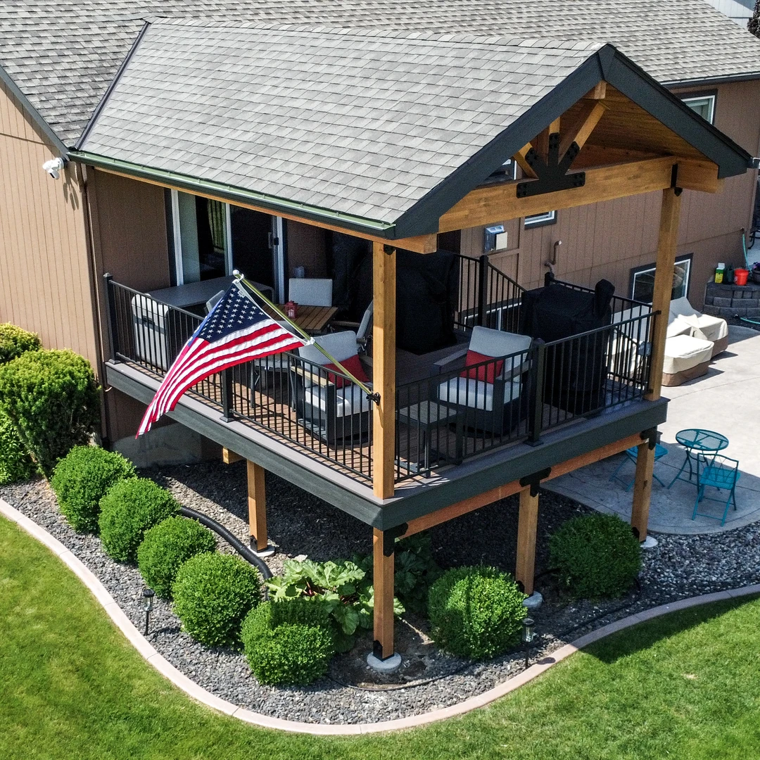 Deck with a cover and American Flag out front.