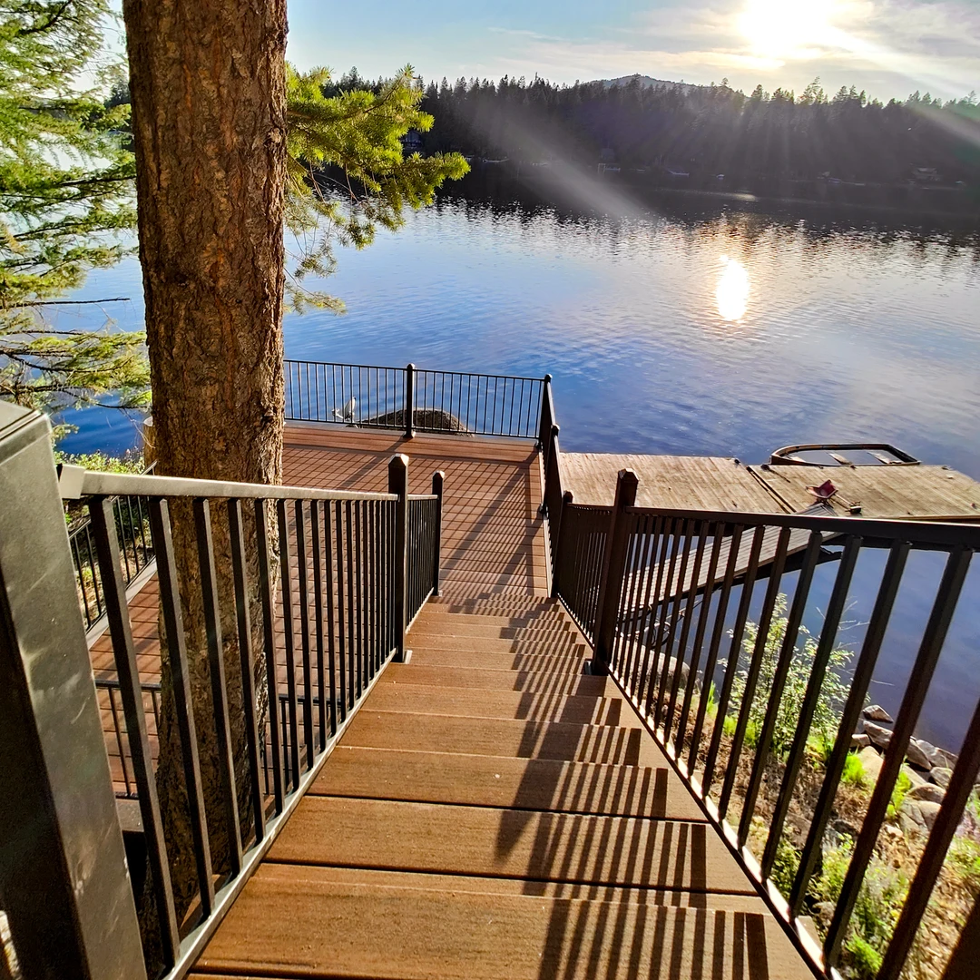 Brown deck with stairs and railing.