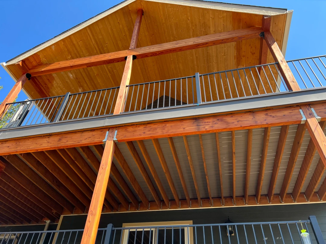 Tongue and groove cover with black picket railing.
