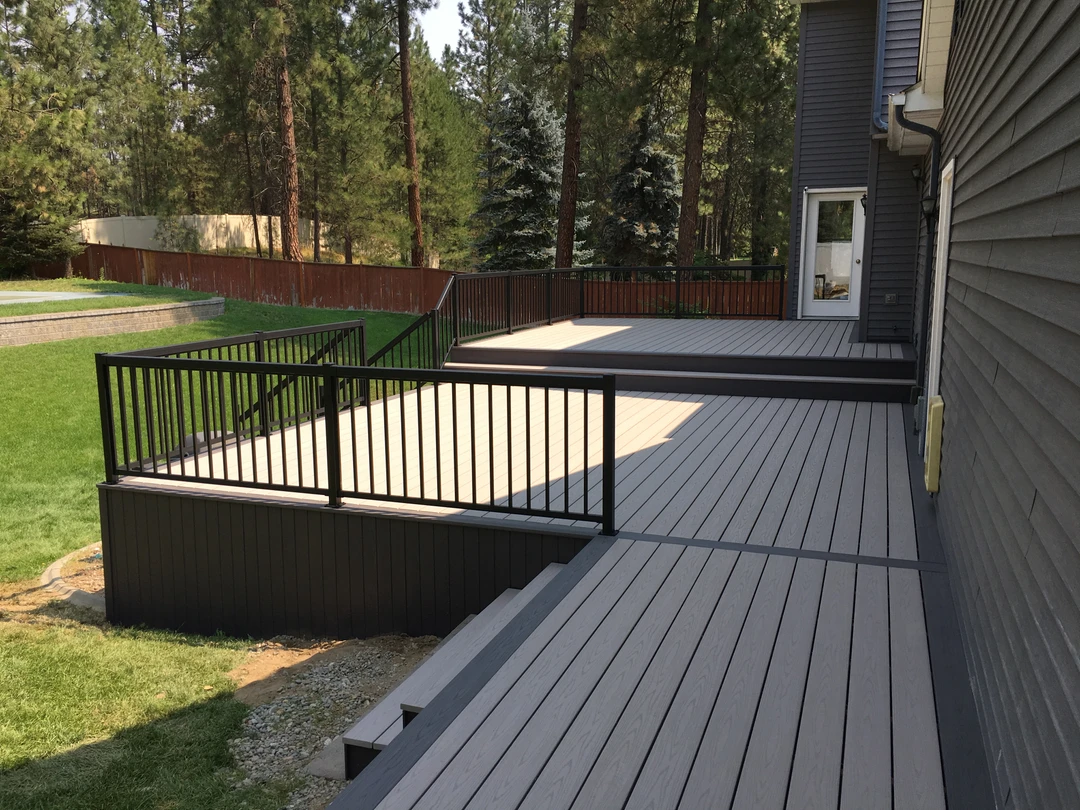 Gray deck with black railing.