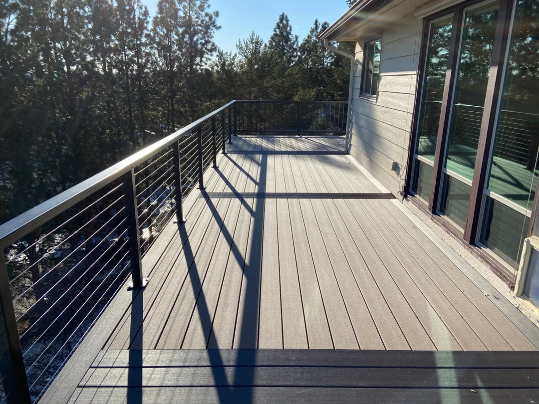 Gray deck with cable railing.