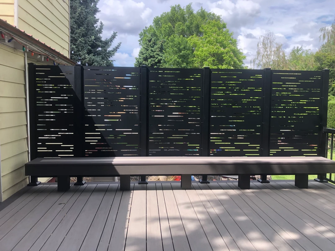 Dashed privacy wall with a tan bench.