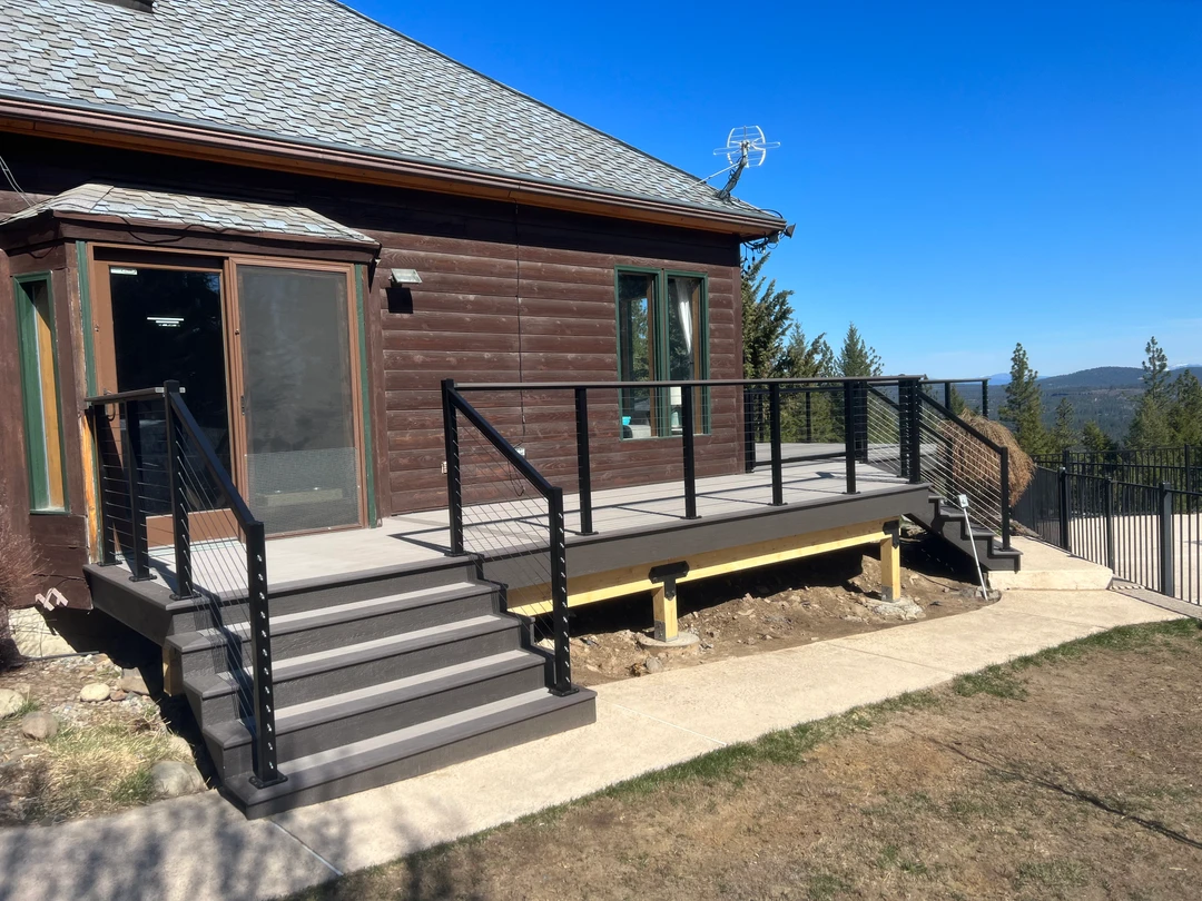 Gray deck with black cable railing.