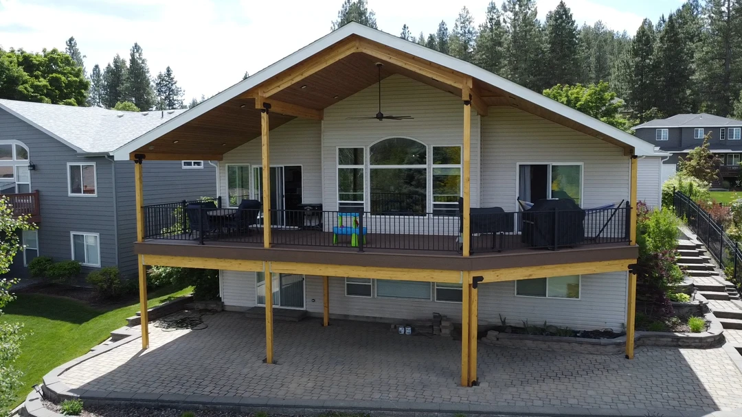 Deck with big cover and black railing.