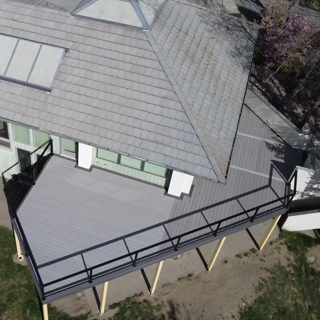 Gray deck with glass railing.