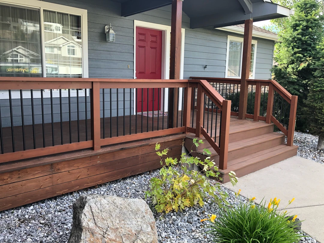 Brown deck with wood railing.