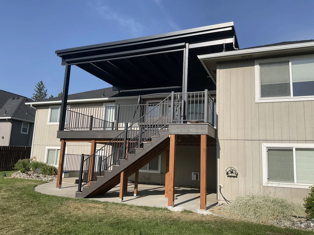 Aluminum pergola installed over deck and attached to the house. Motorized louvered pergola. Powder coated aluminum railing. 