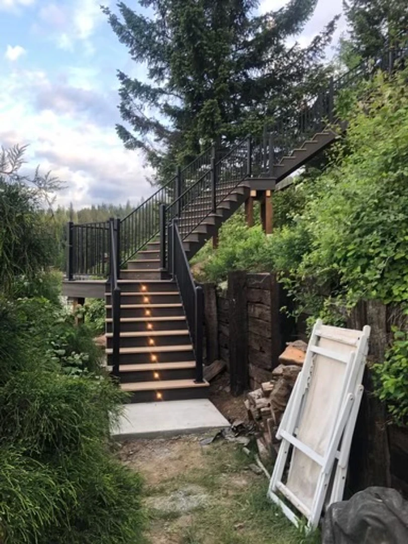 Long staircase replacement. Stair replacement builder. New composite or pvc stairs. Lighting installed new staircase. 