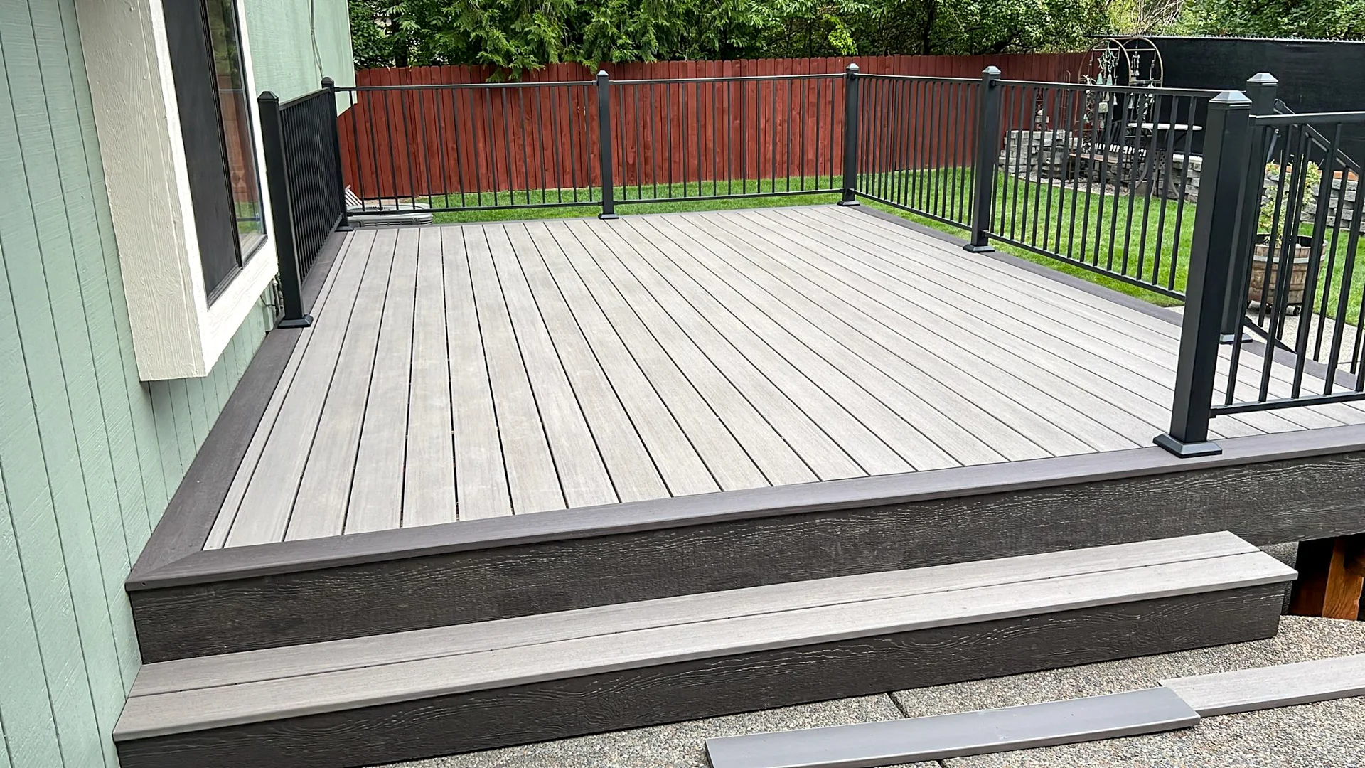 Deck with a nice railing going around it.