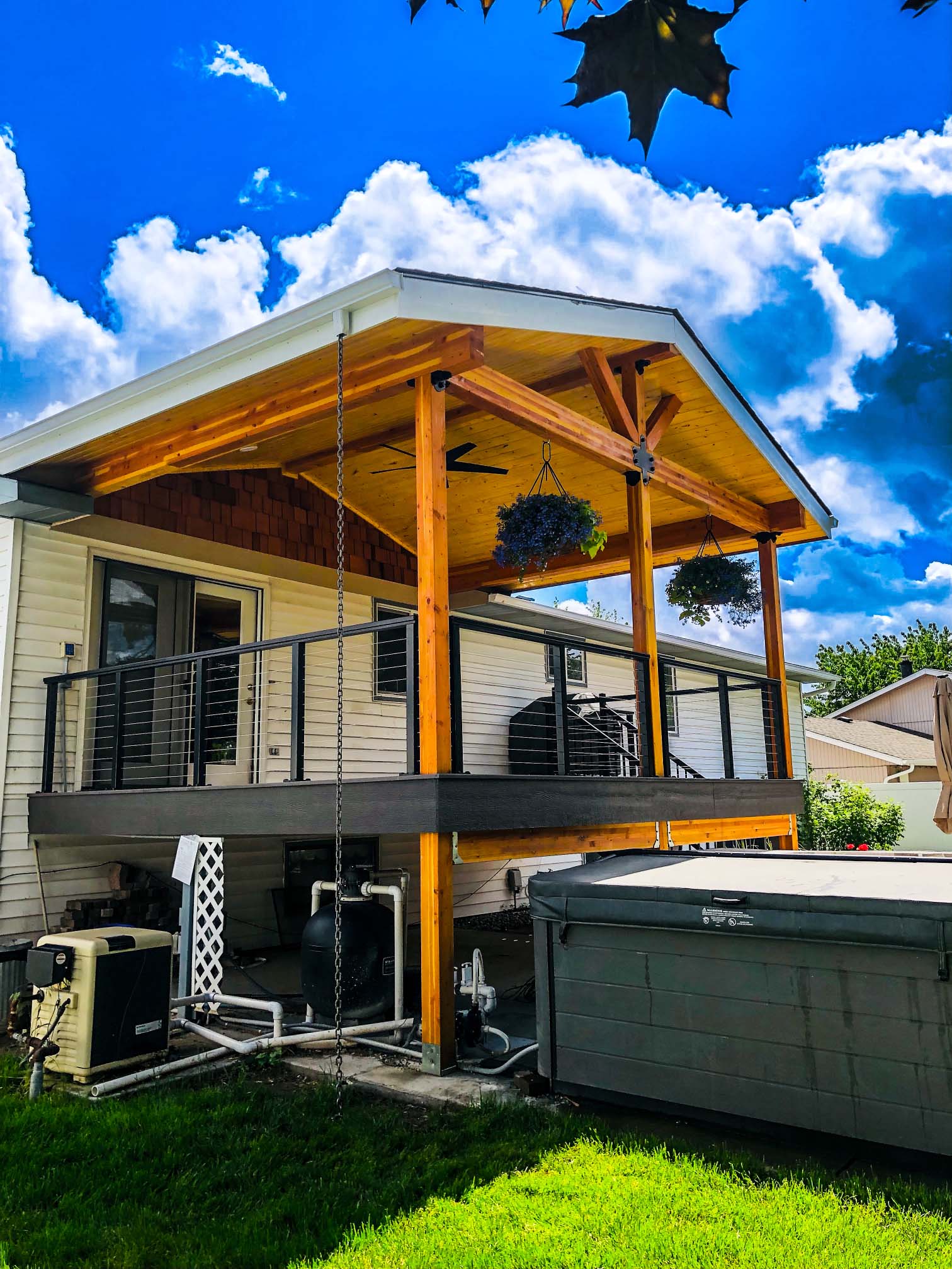 Beautiful sky and a gorgeous deck with a stylish cover over it.